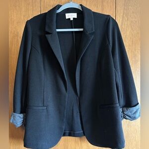 Black open-front blazer with gray rolled cuff